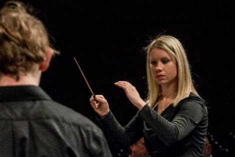 Music conductor with baton